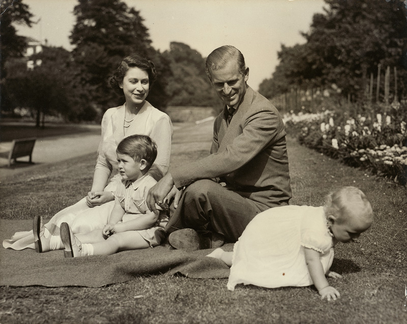 Lot 4140, Auction  120, Elizabeth II, Queen, Princess Elizabeth and the Duke of Edinburgh with their two children, Prince Charles and Princess Anne, in the garden at Clarence House, London