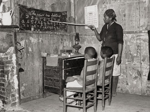 Lot 4220, Auction  124, Lee, Russell, Negro mother teaching children numbers and alphabet in home of sharecropper, Transylvania, Louisiana; Daughter of sharecroppers, New Madrid County, Missouri