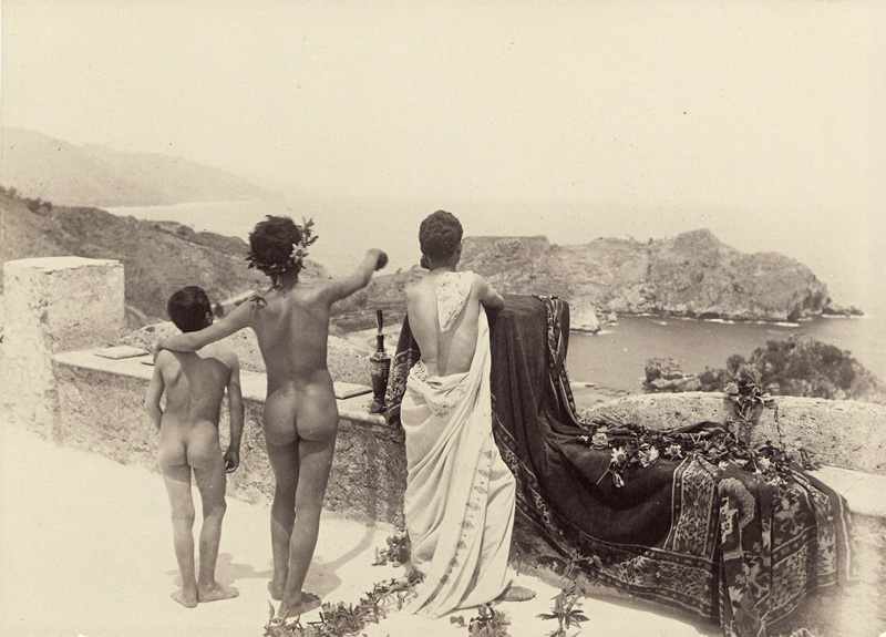 Lot 4044, Auction  126, Gloeden, Wilhelm von, Arcadian scene with a group of nude youths on terrace overlooking the sea